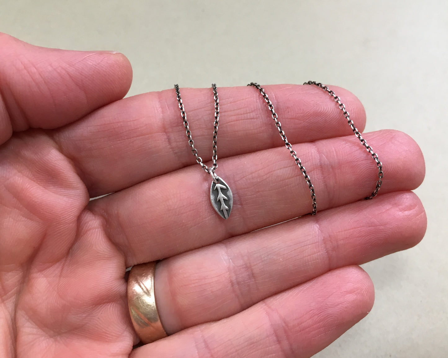 Tiny silver leaf necklace in oxidized sterling silver