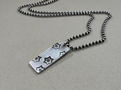 Silver stamped flower dog tag necklace