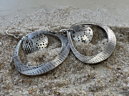 Silver seashell statement earrings with beach sand inclusions