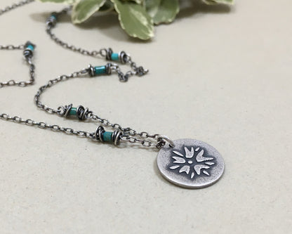 Silver flower charm on turquoise beaded chain