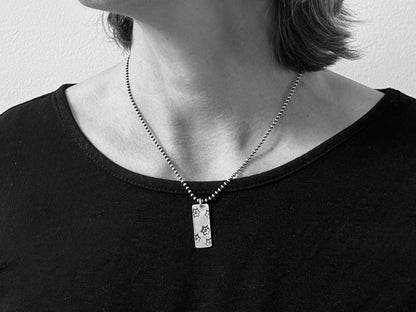 Silver stamped flower dog tag necklace