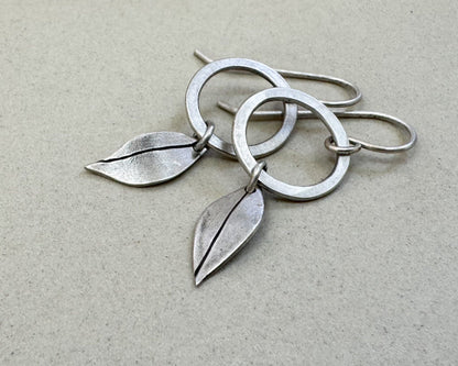 Little silver hoops with simple leaves in a brushed satin finish