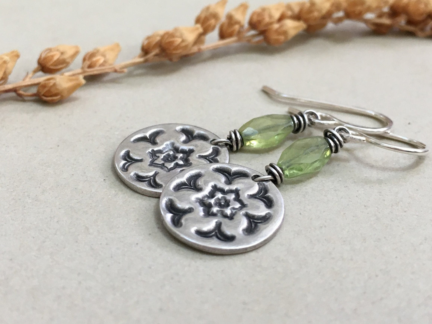 Silver stamped flower earrings with green peridot