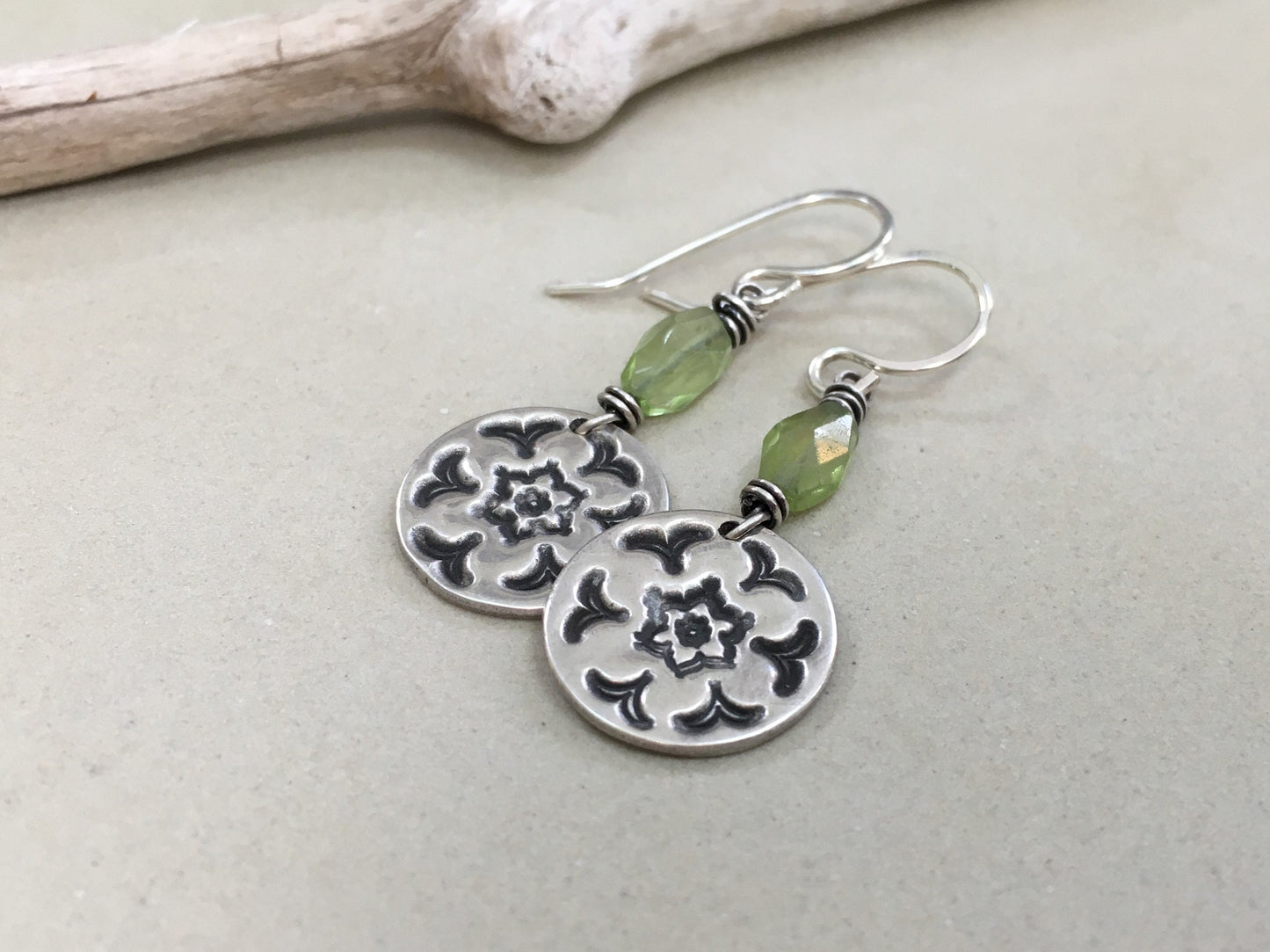 Silver stamped flower earrings with green peridot