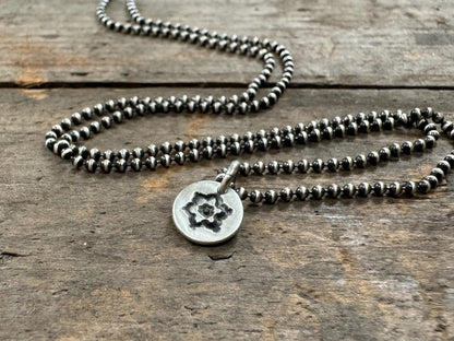 Tiny stamped flower necklace in oxidized sterling silver