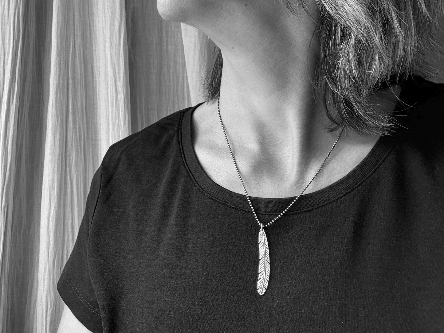 Tribal style silver feather necklace on leather or chain