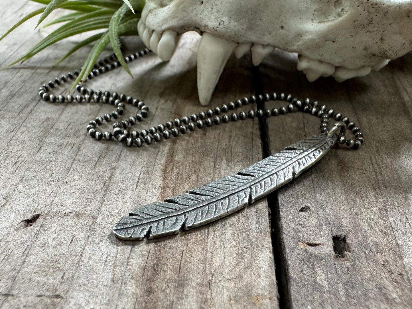 Tribal style silver feather necklace on leather or chain