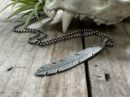 Tribal style silver feather necklace on leather or chain
