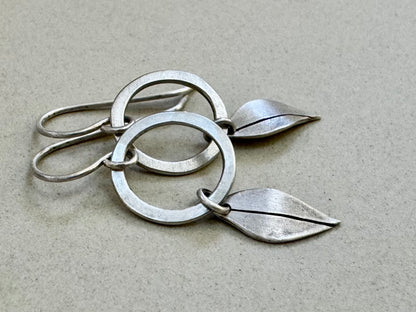 Little silver hoops with simple leaves in a brushed satin finish