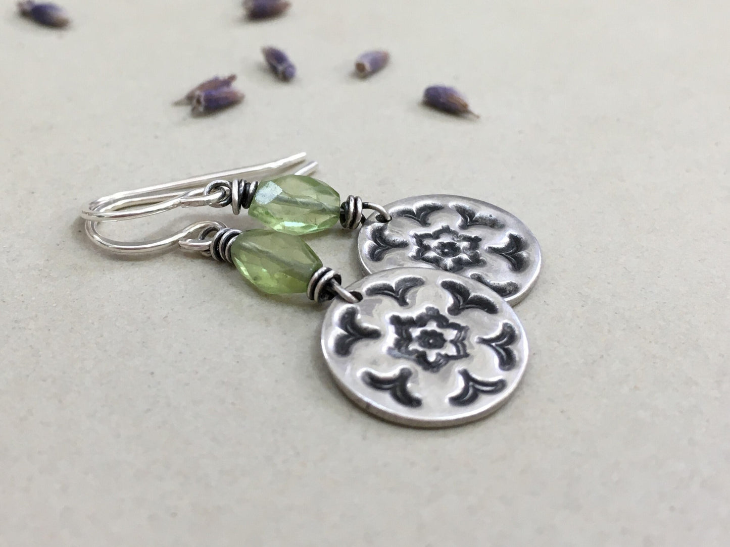 Silver stamped flower earrings with green peridot