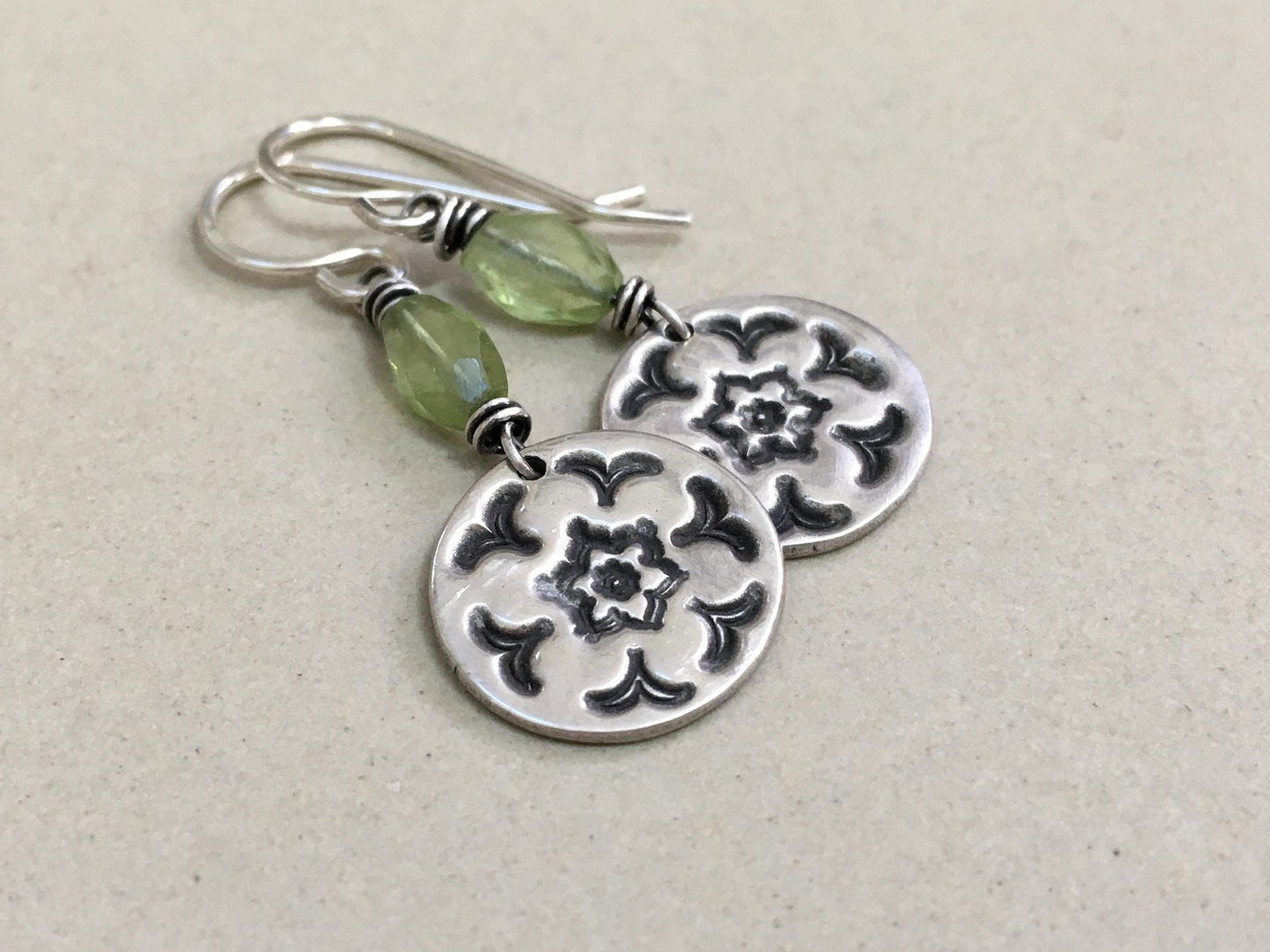 Silver stamped flower earrings with green peridot