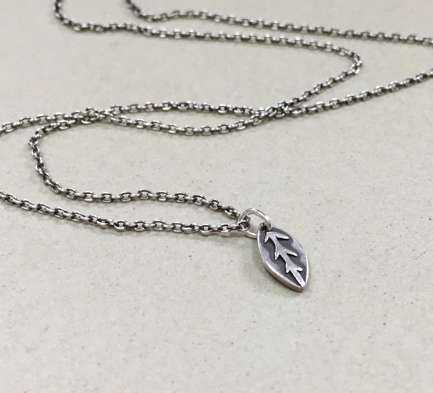 Tiny silver leaf necklace in oxidized sterling silver