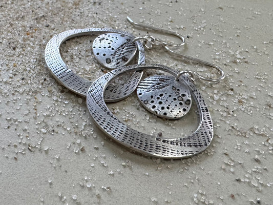 Silver seashell statement earrings with beach sand inclusions