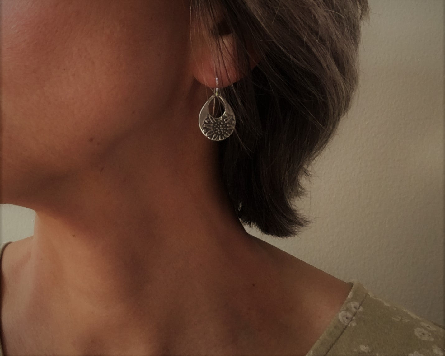 Silver teardrop earrings with sunflower design