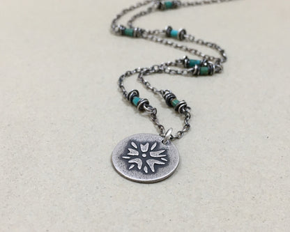 Silver flower charm on turquoise beaded chain