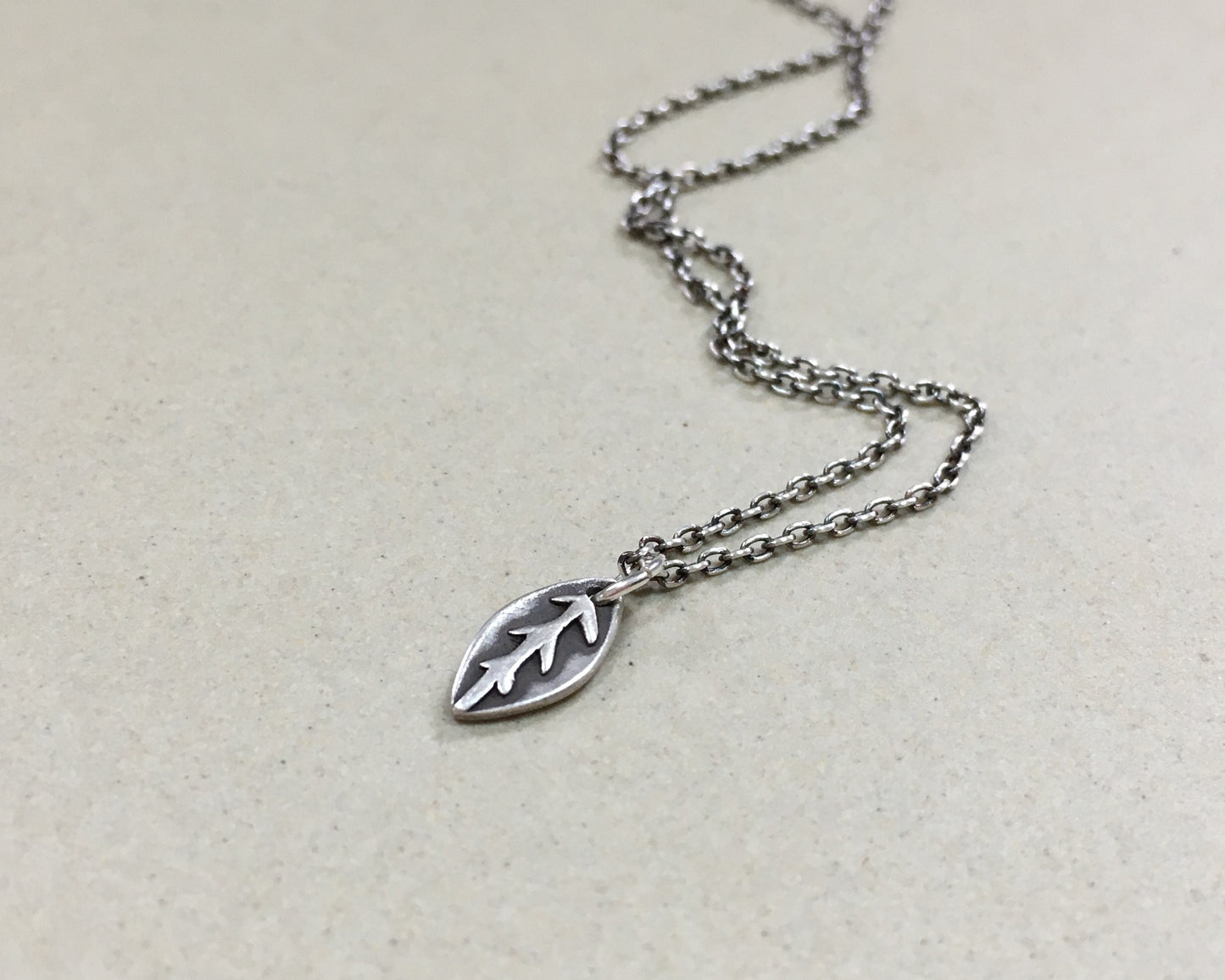 Tiny silver leaf necklace in oxidized sterling silver