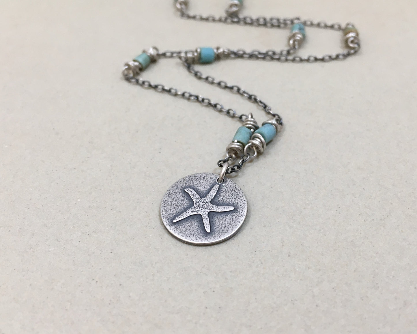 Silver starfish necklace on beaded chain