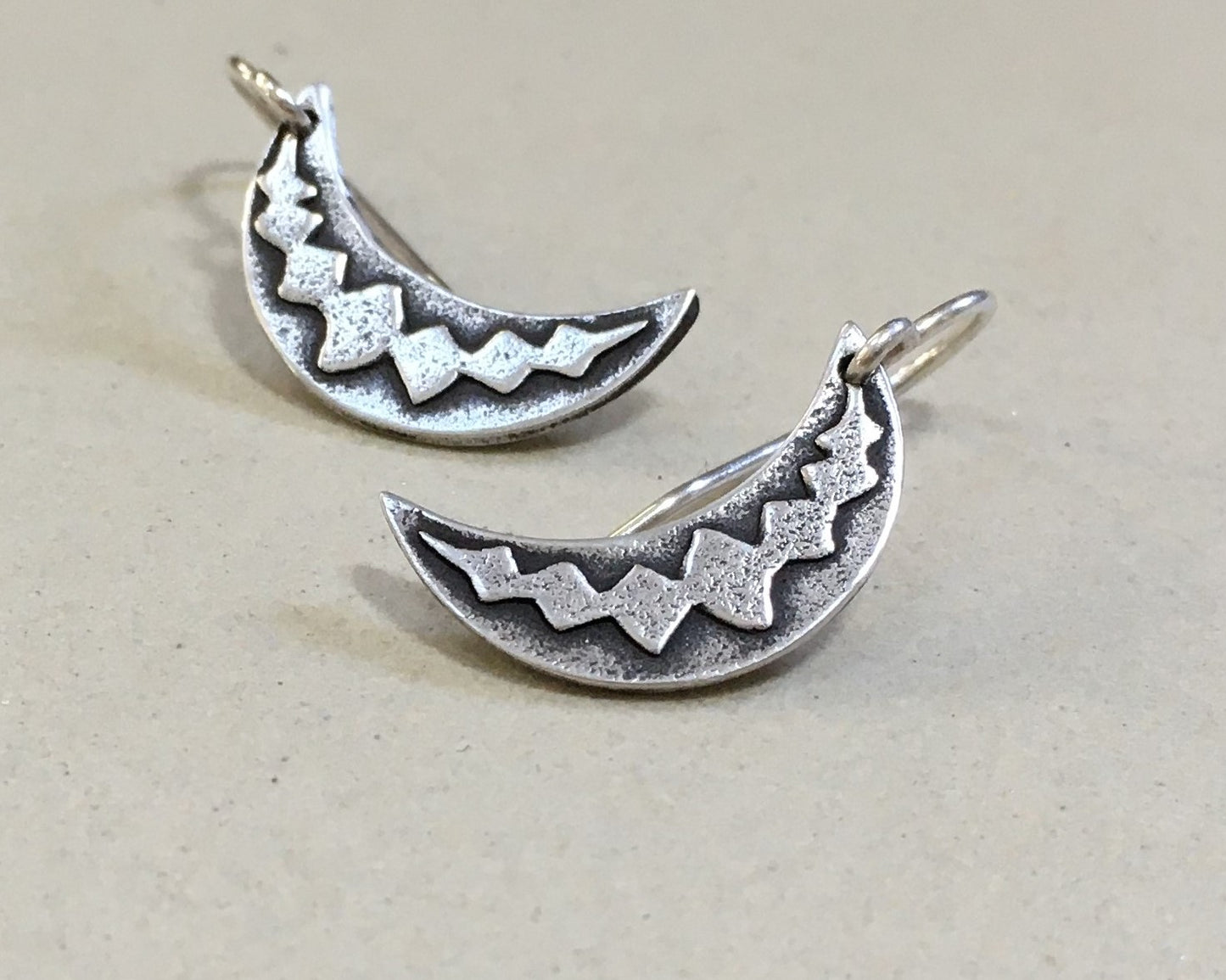 Silver crescent moon earrings with simple rustic design