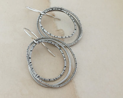 Multiple textured hoop earrings in oxidized sterling silver