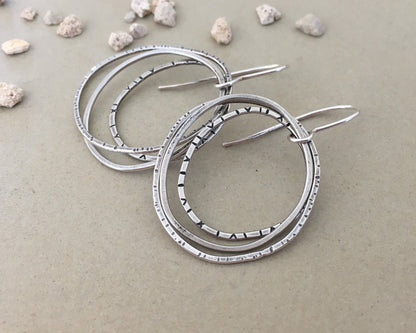 Multiple textured hoop earrings in oxidized sterling silver