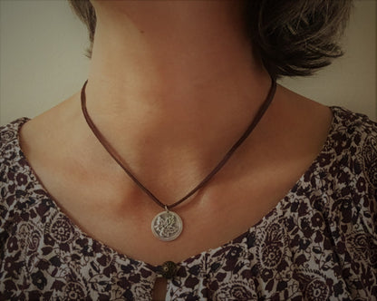 Silver maple leaf pendant on leather
