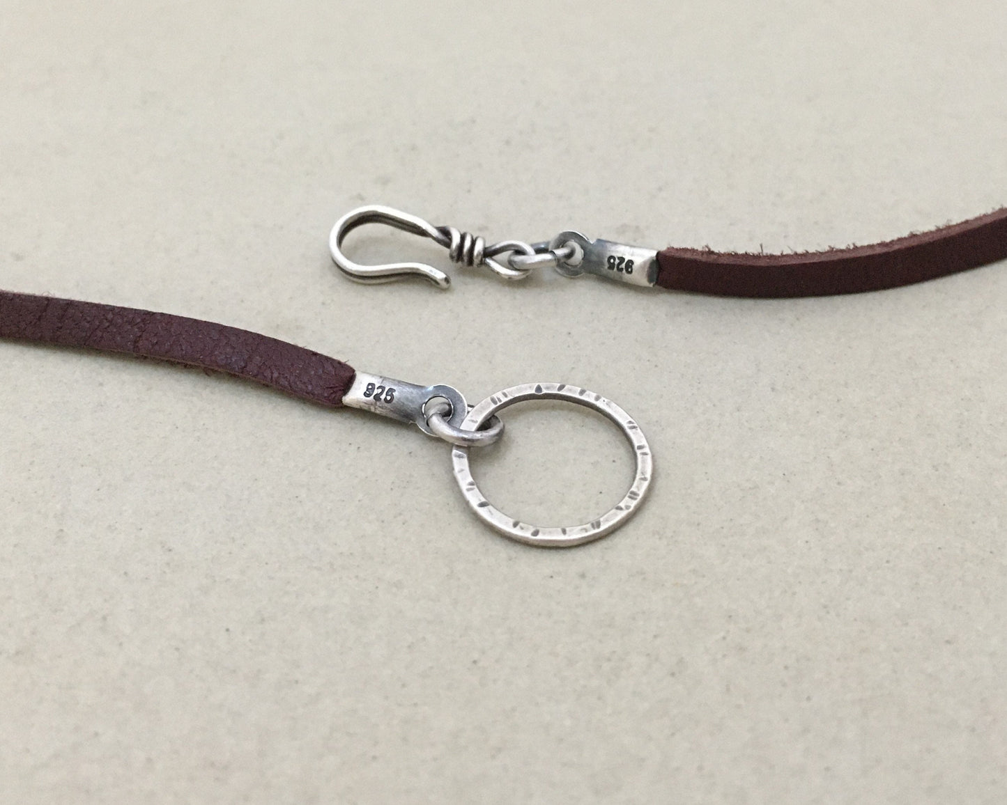 Silver floral medallion on soft leather lace