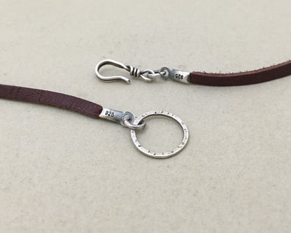 Silver floral medallion on soft leather lace