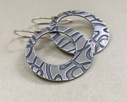 Stylized swirly hoops in oxidized sterling silver
