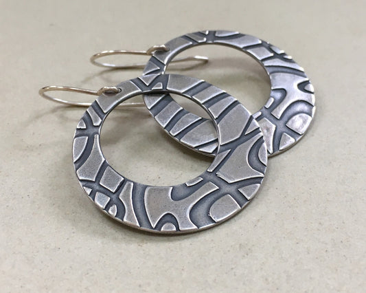 Stylized swirly hoops in oxidized sterling silver