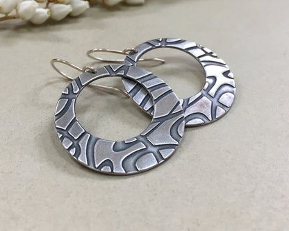 Stylized swirly hoops in oxidized sterling silver