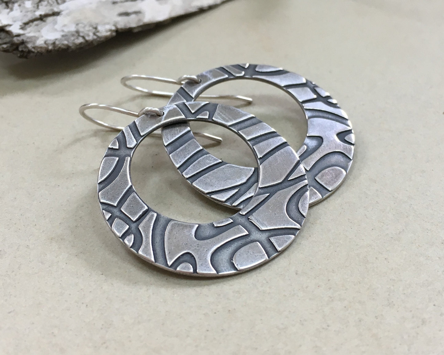 Stylized swirly hoops in oxidized sterling silver