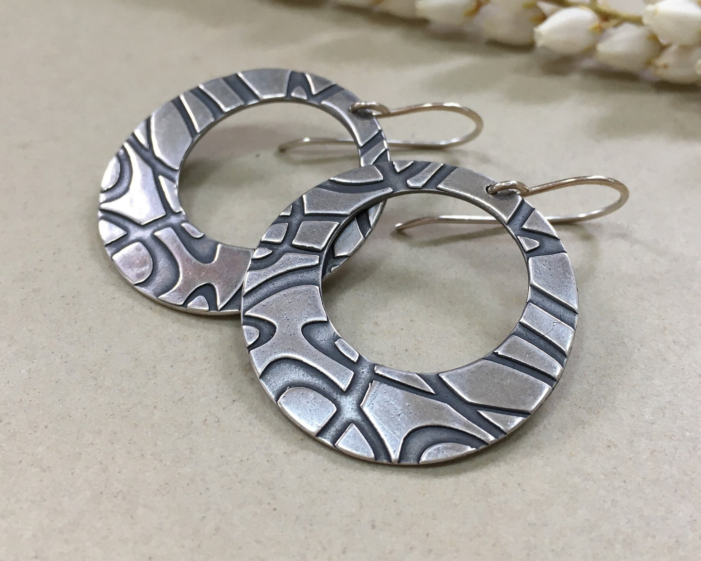 Stylized swirly hoops in oxidized sterling silver