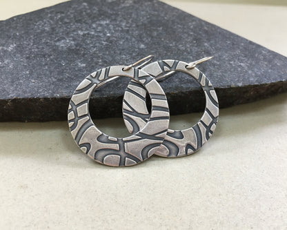 Stylized swirly hoops in oxidized sterling silver