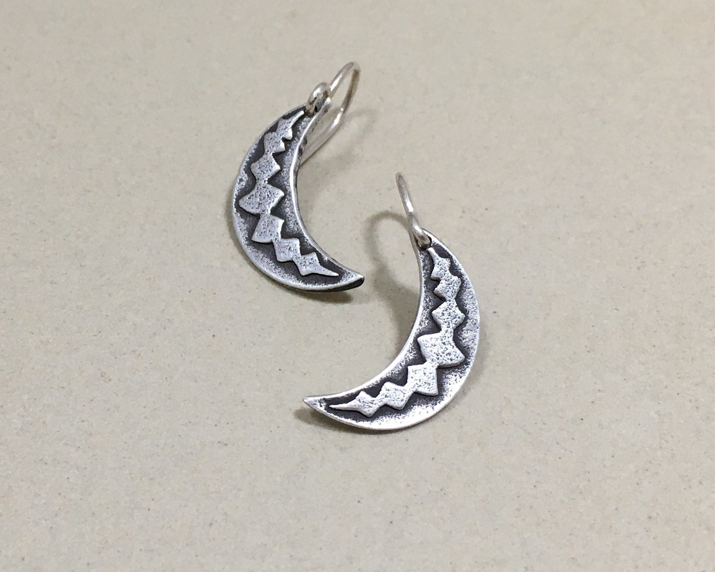 Silver crescent moon earrings with simple rustic design
