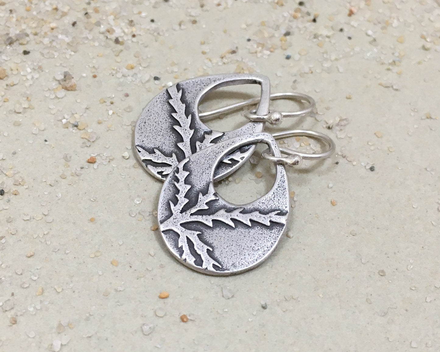 Botanical evergreen design on silver teardrop earrings
