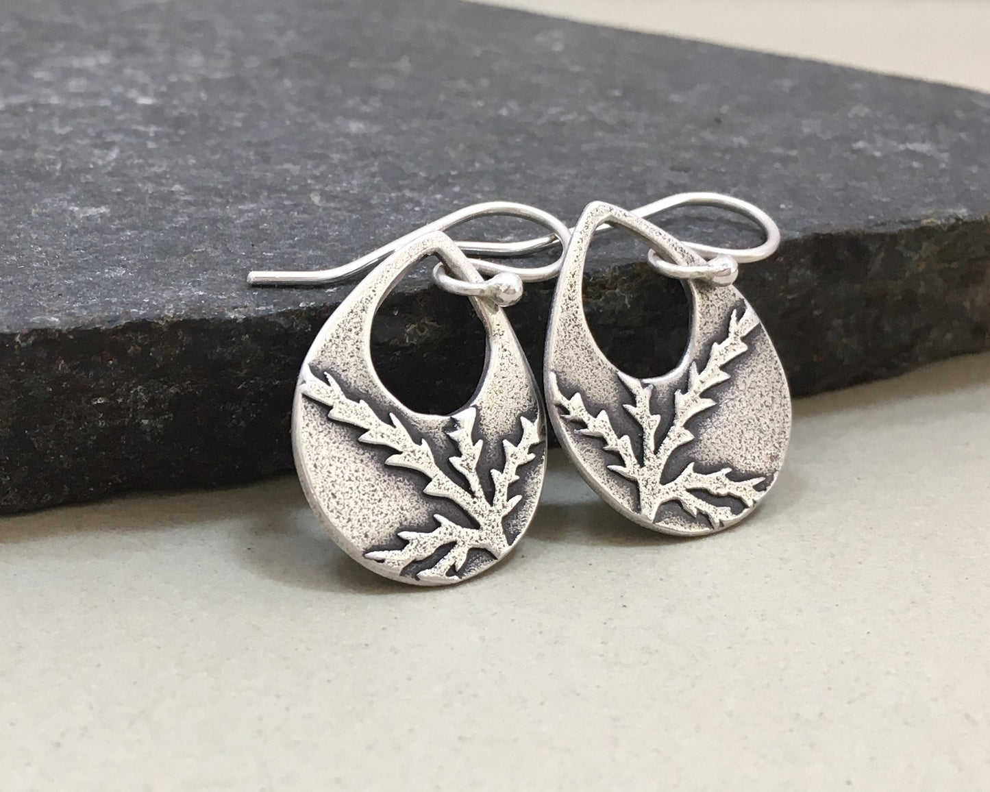 Botanical evergreen design on silver teardrop earrings