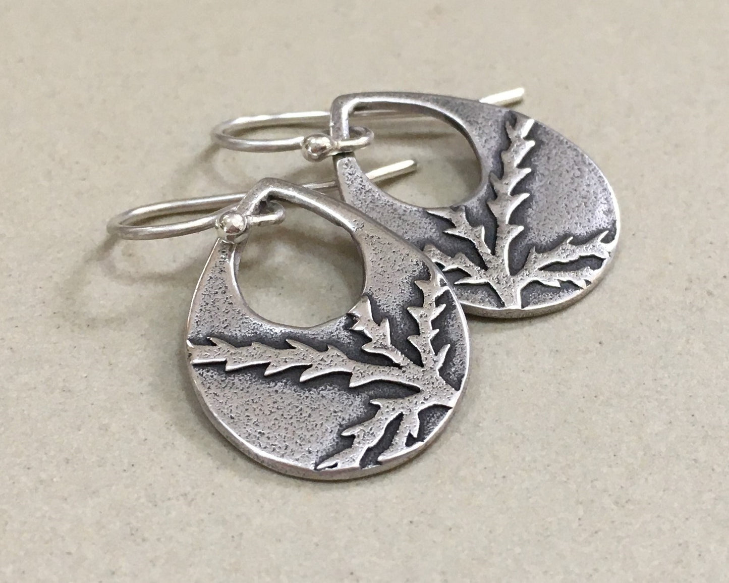 Botanical evergreen design on silver teardrop earrings