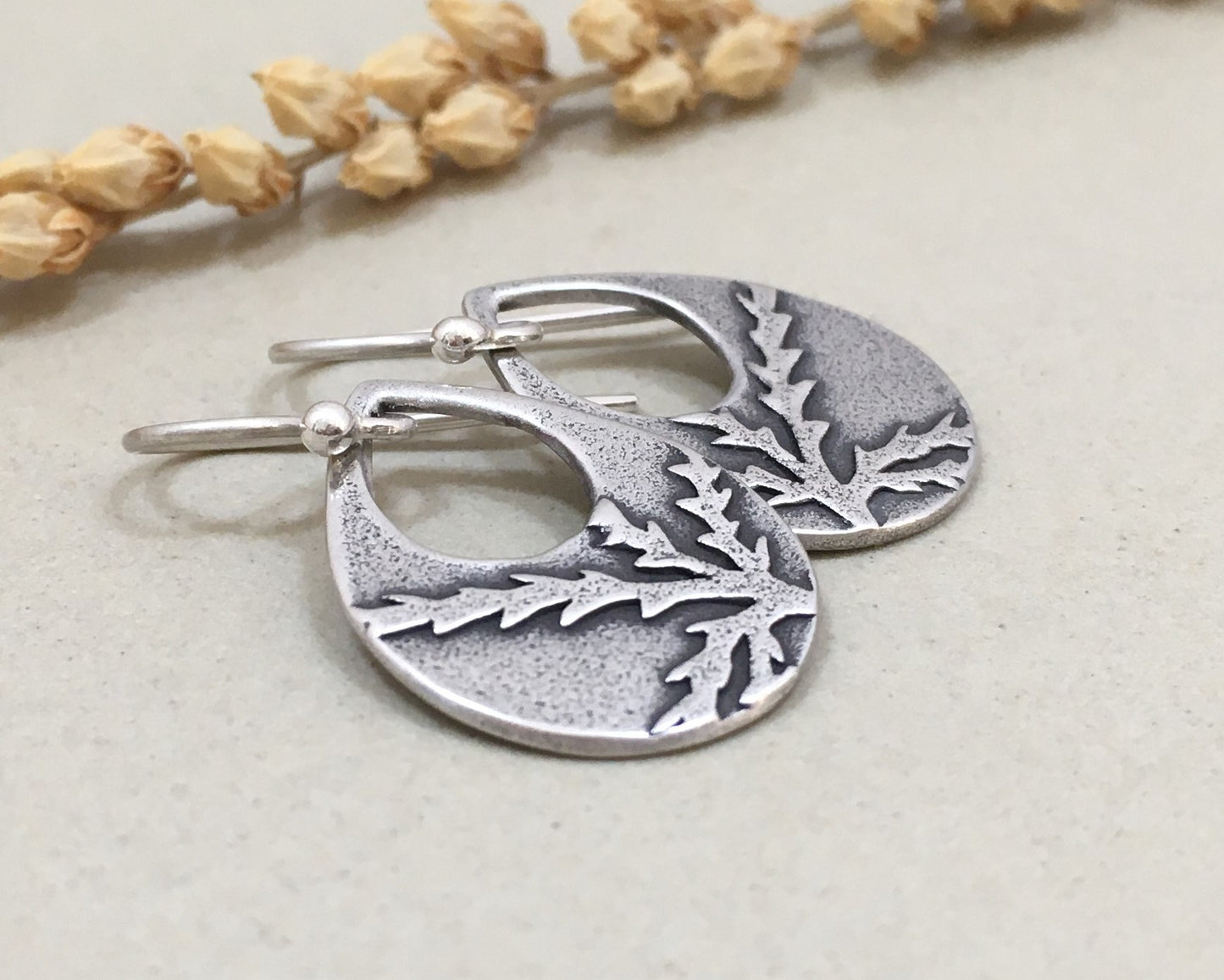 Botanical evergreen design on silver teardrop earrings
