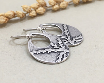 Botanical evergreen design on silver teardrop earrings