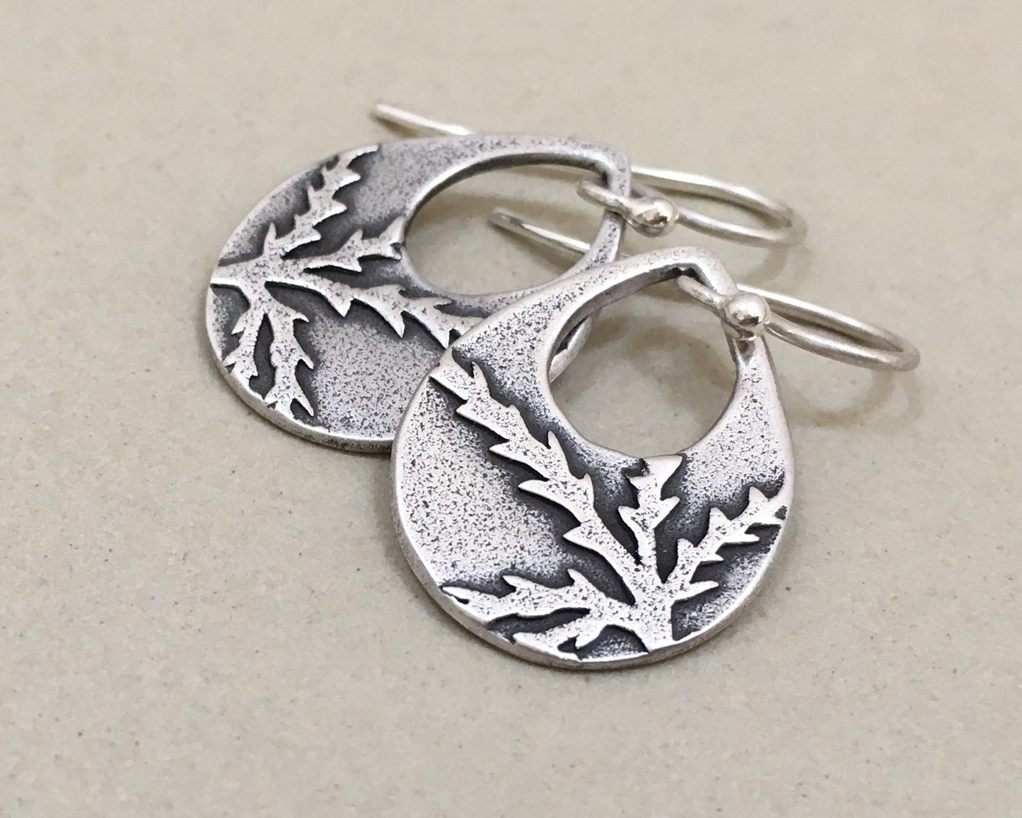 Botanical evergreen design on silver teardrop earrings