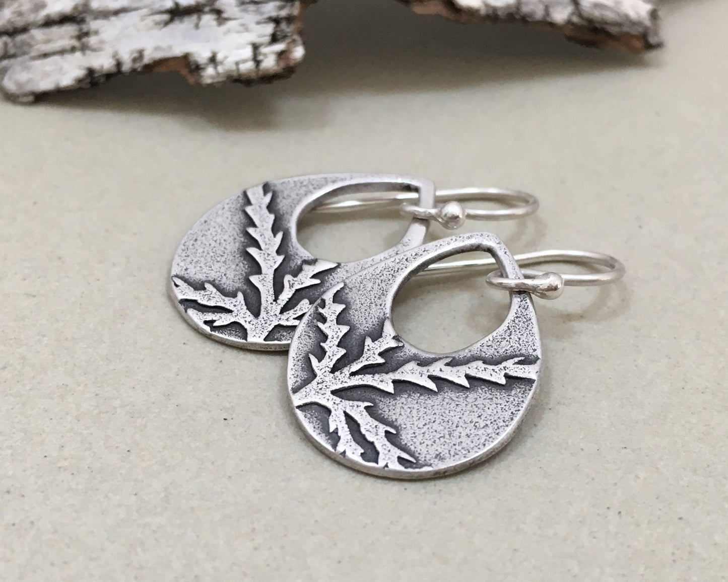 Botanical evergreen design on silver teardrop earrings