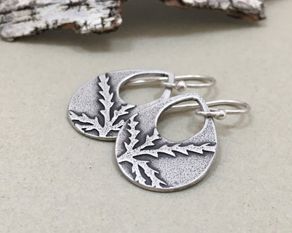 Botanical evergreen design on silver teardrop earrings