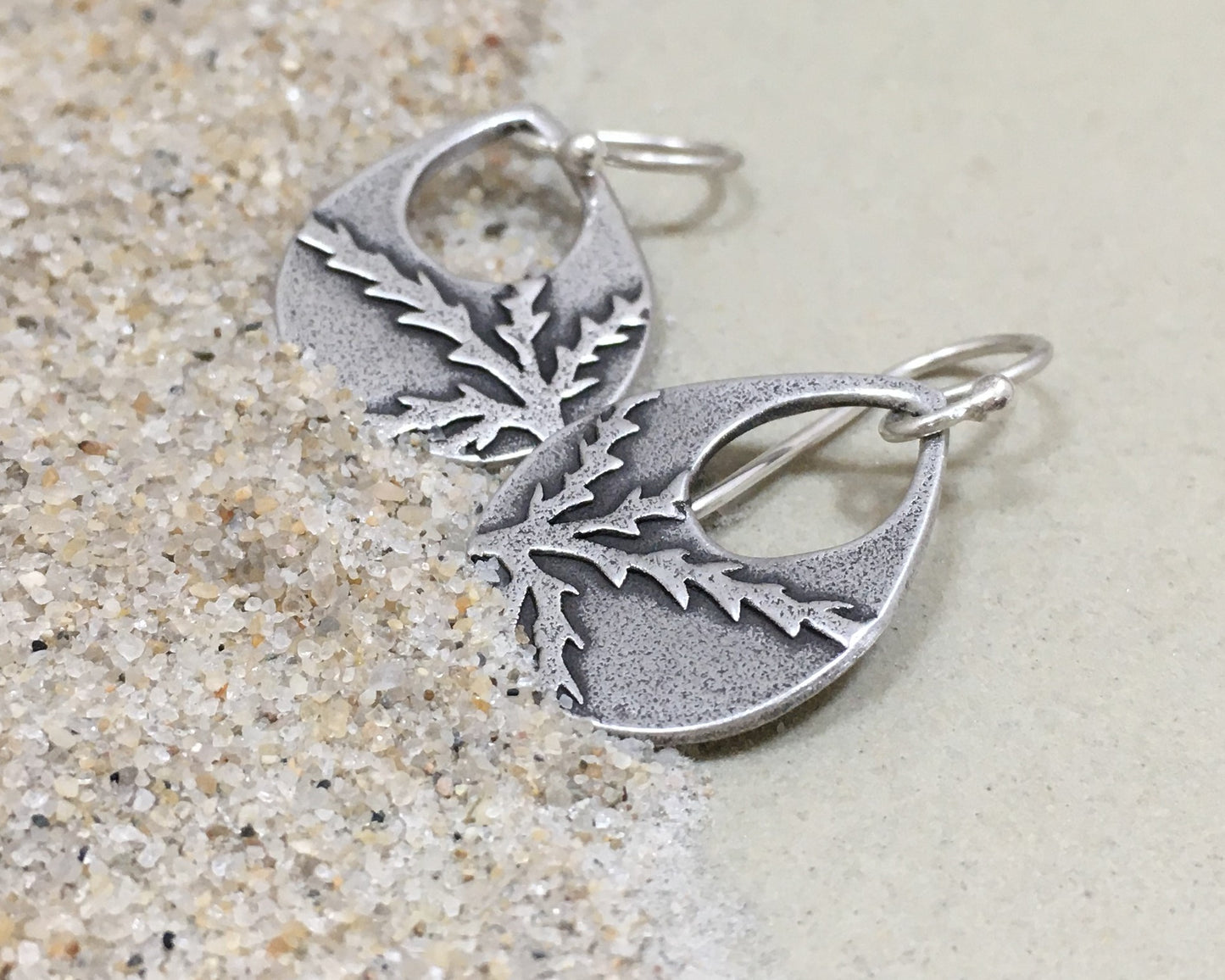 Botanical evergreen design on silver teardrop earrings