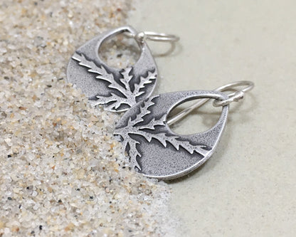 Botanical evergreen design on silver teardrop earrings