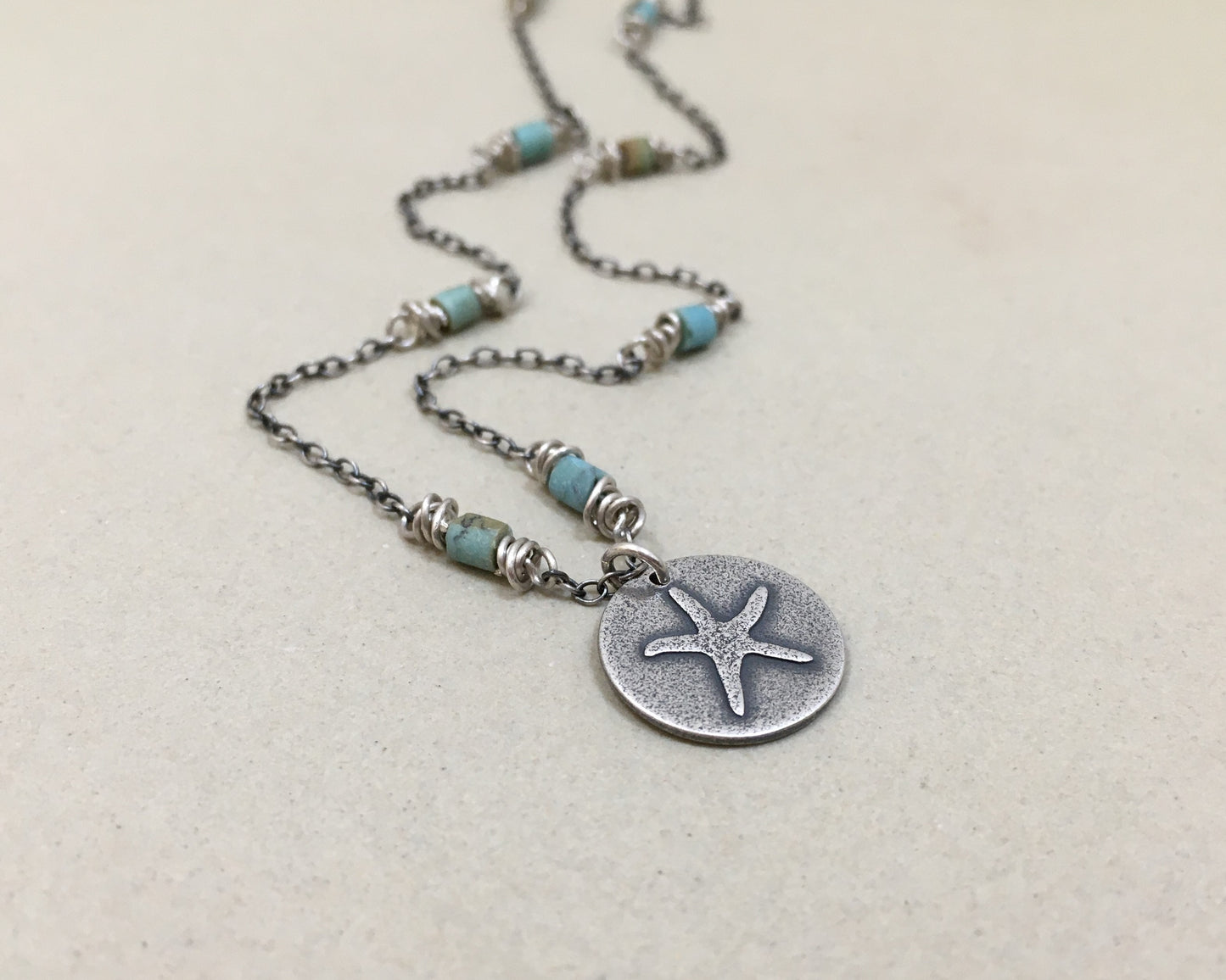 Silver starfish necklace on beaded chain
